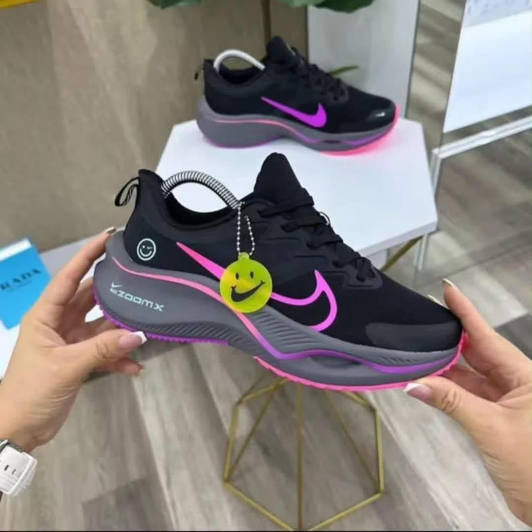 Nike ZoomX black running shoes with pink accents